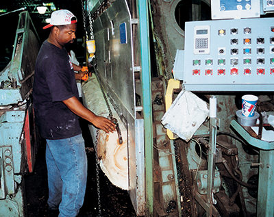 Worker at veneer slicing machine